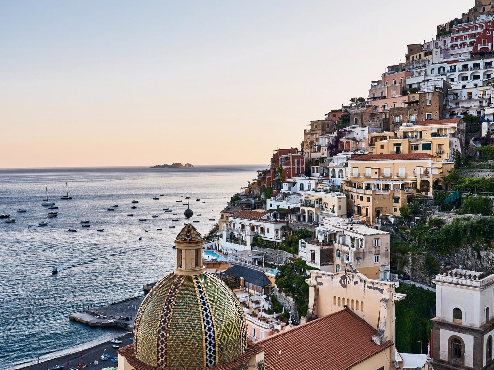 View from Le Sirenuse of the church dome, Positano’s houses and boats in the sea bay